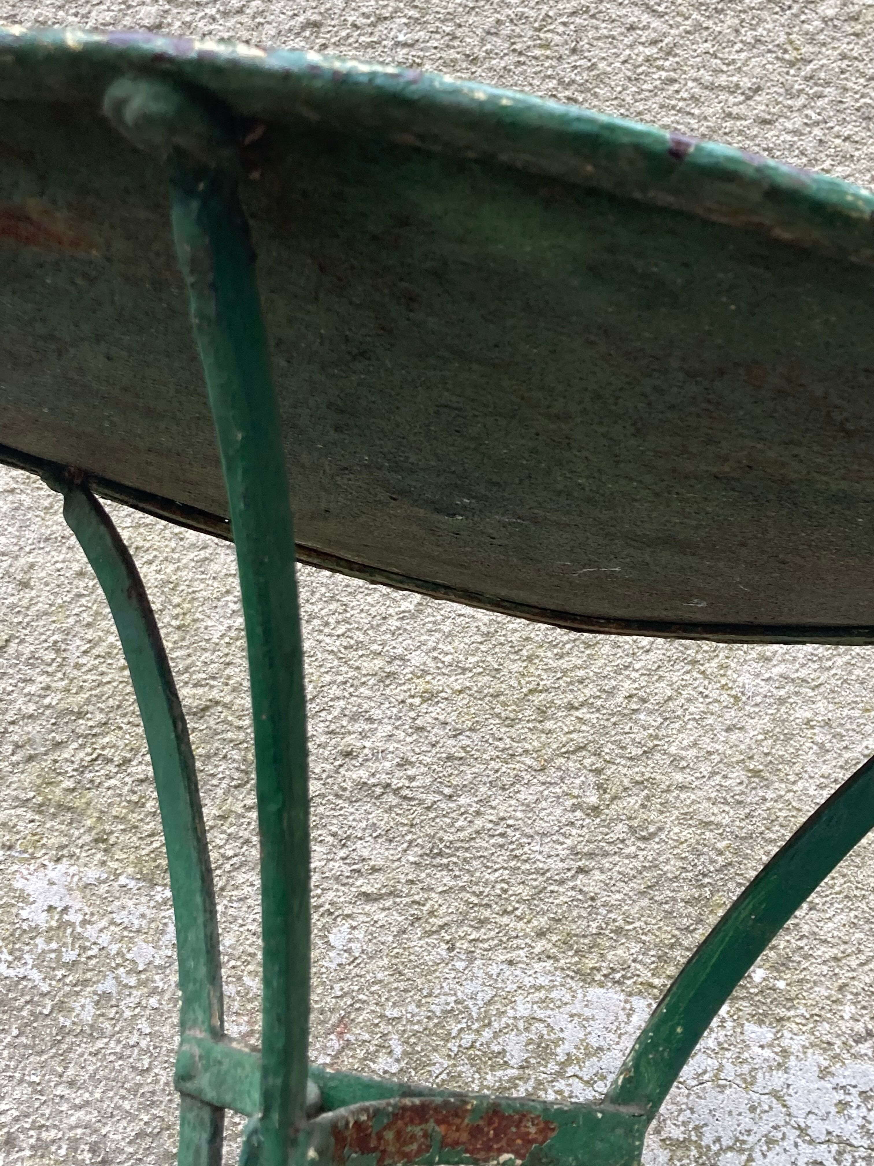 Riveted green old garden pedestal table