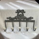 Patinated metal wall bracket and porcelain
