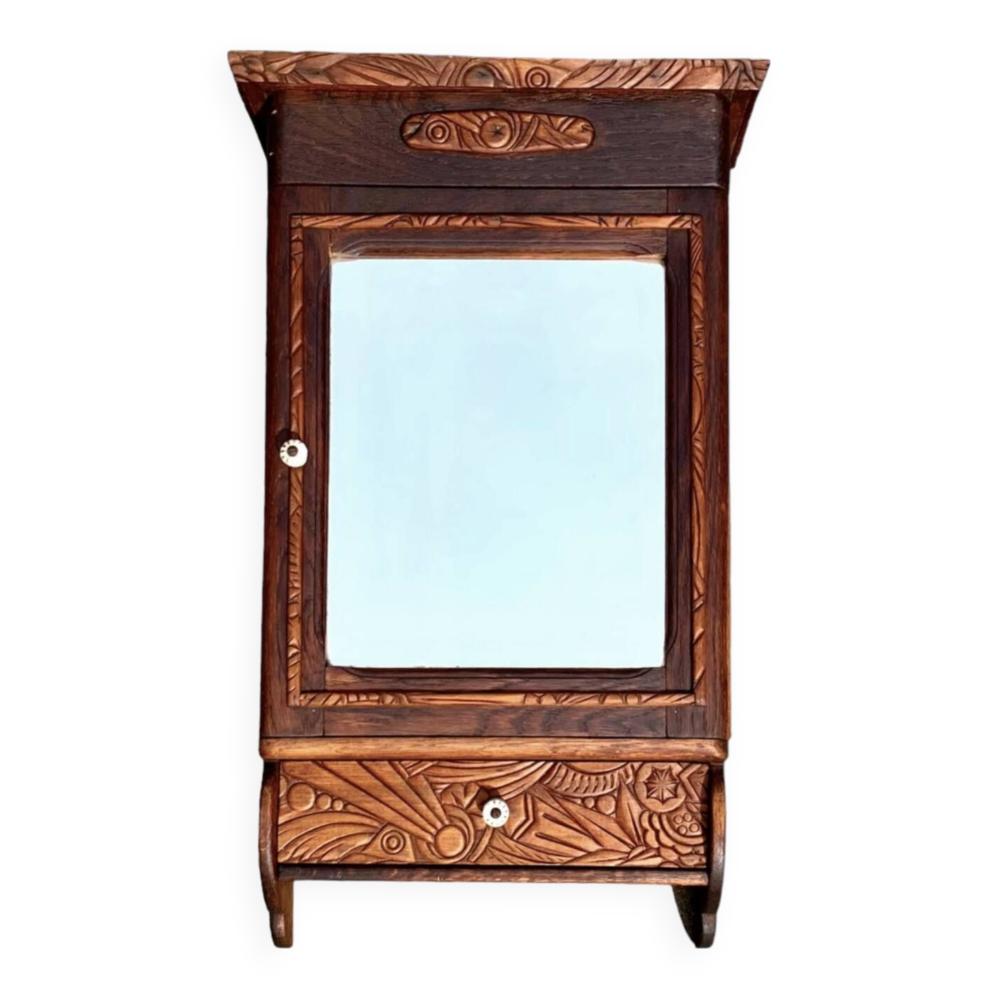 Old carved wooden medicine cabinet with beveled mirror