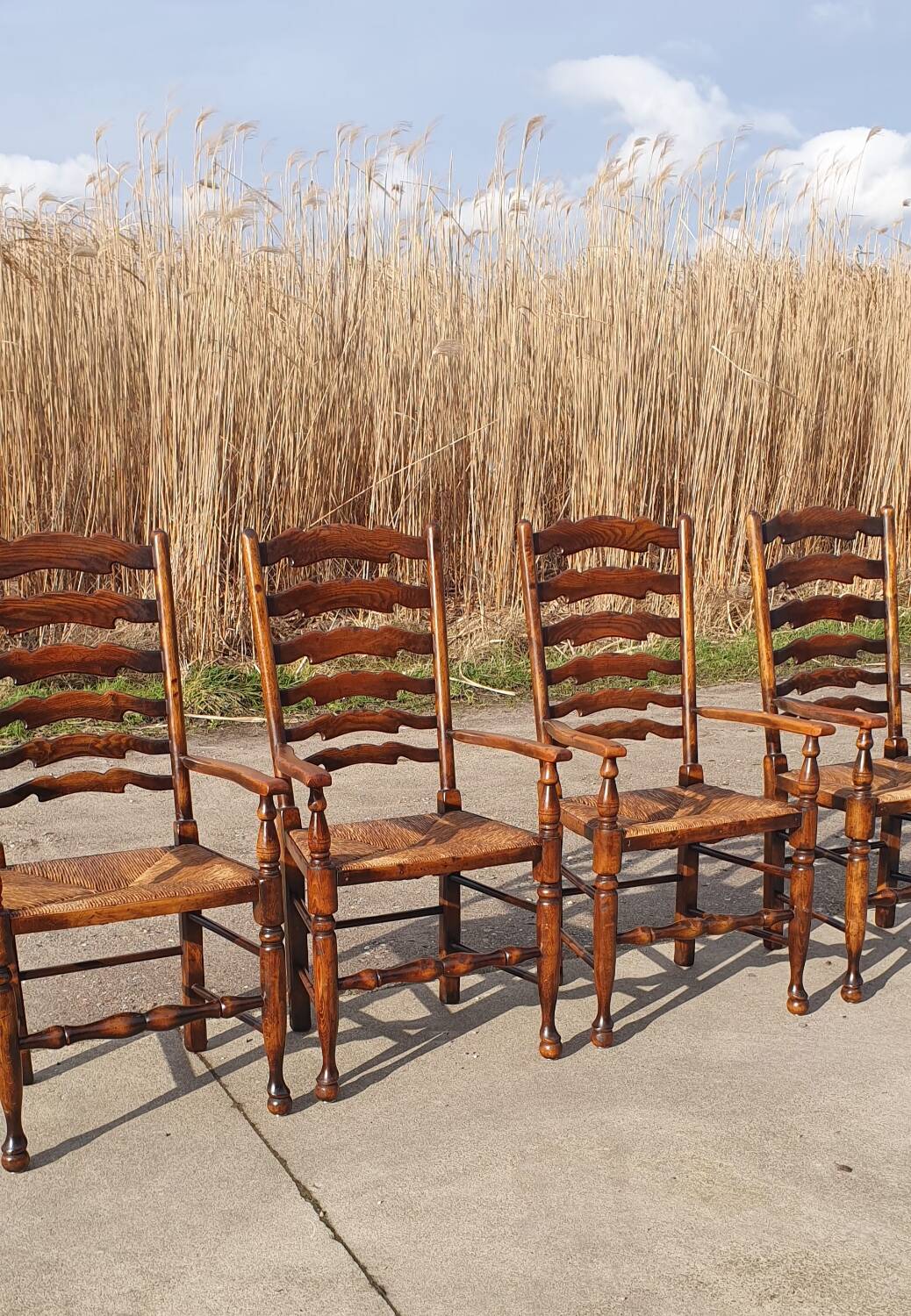 Set of 4 rustic vintage armchairs in English farmhouse style with rush seats.