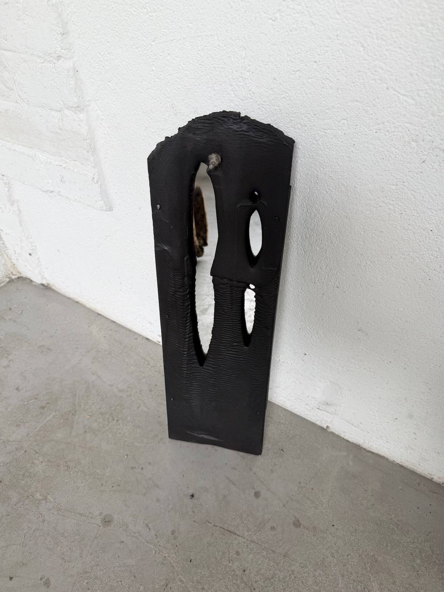 Brutalist hammered mirror, free-form, patinated metal.