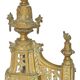 Pair of gilded brass fire dogs decorated with fire pots in the Louis XVI style.