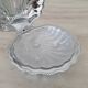Shell-shaped butter dish in stainless steel and white glass bowl.