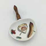 Ceramic aperitif dish and wooden handle.