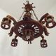 French vintage Breton chandelier with hand-carved figures, well, and lantern lights.