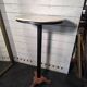 Bistro standing table with marble top and cast iron base.