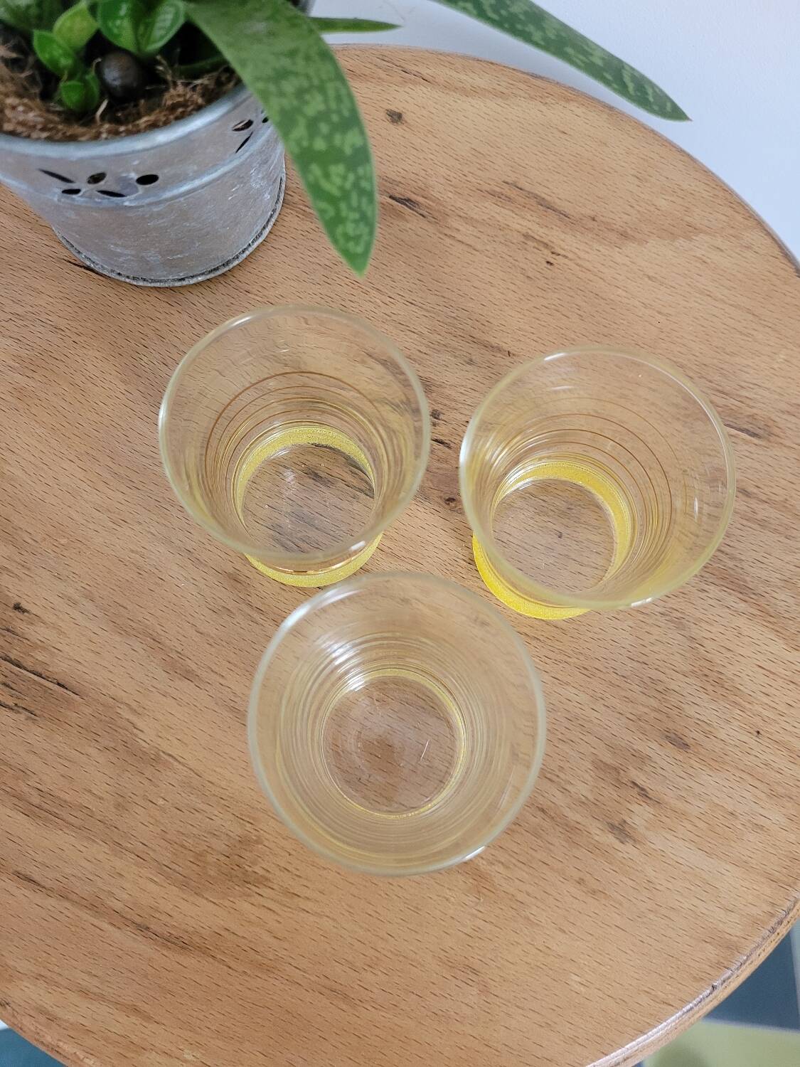 Trio of small yellow granite glasses with gold rims