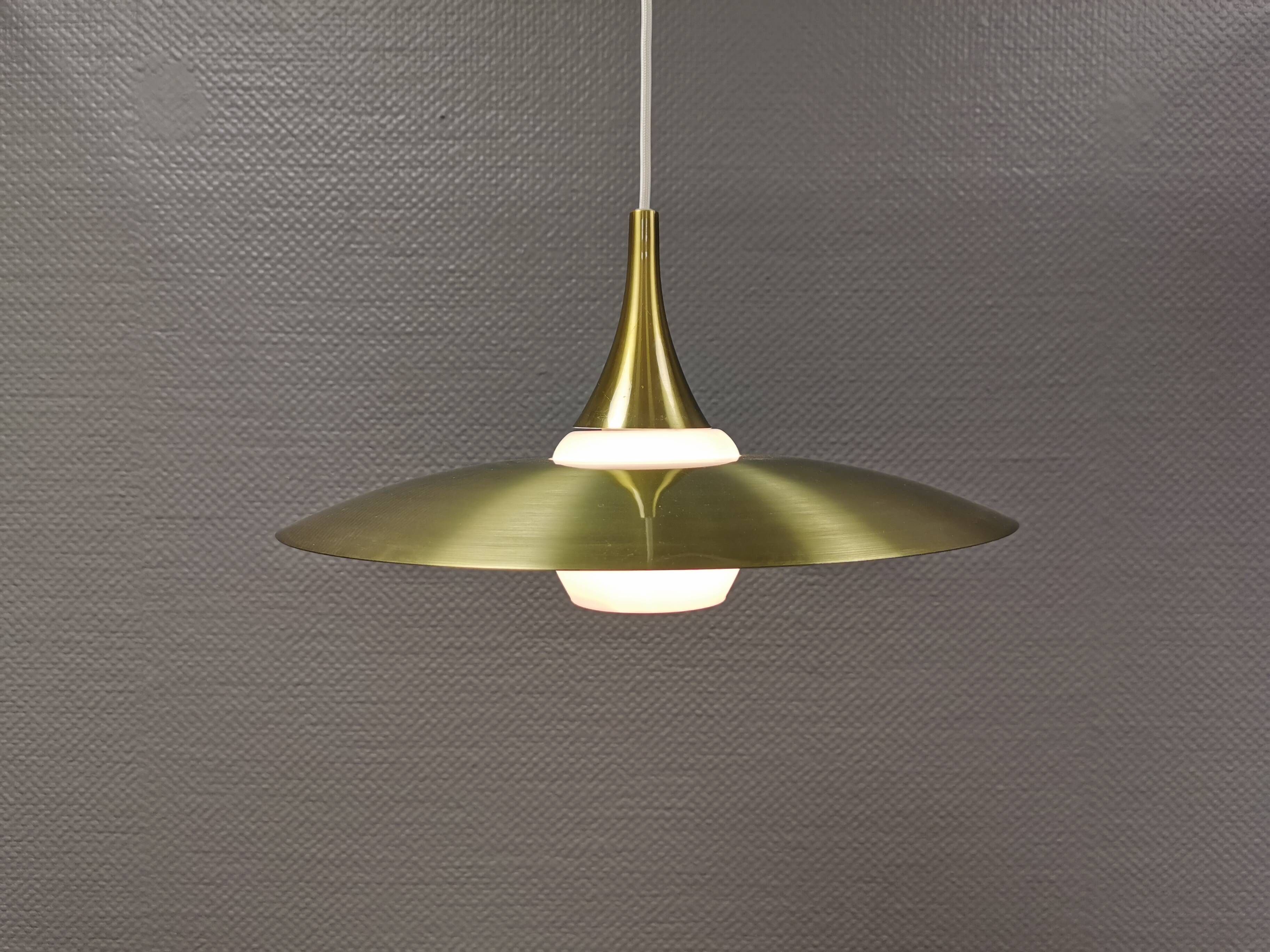 Hanging lamp, from the 1970s in matte white glass and brass colored metal.