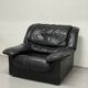 Vintage black leather lounge chair — low postmodern club chair from the space age.