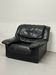 Vintage black leather lounge chair — low postmodern club chair from the space age.