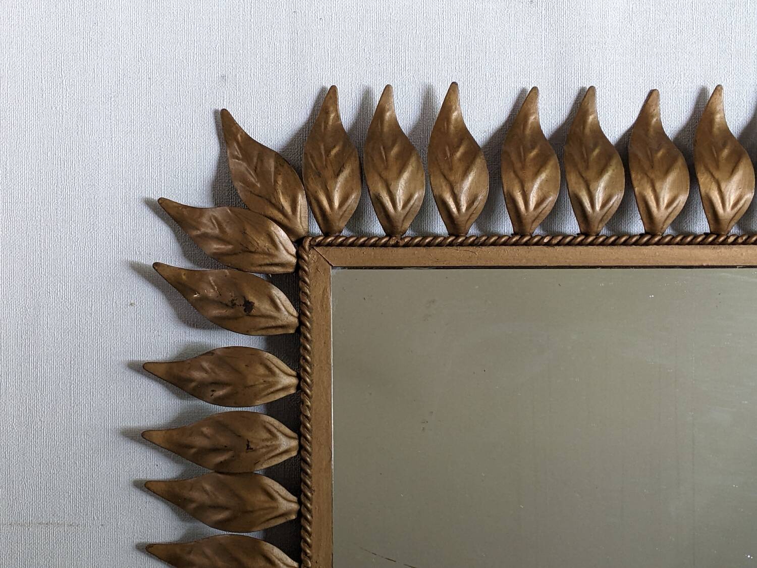 Vintage gold metal mirror with leaves from the 1950s.