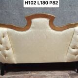 Banquette vintage à dossier capitonné, revêtu d’un tissu ivoire