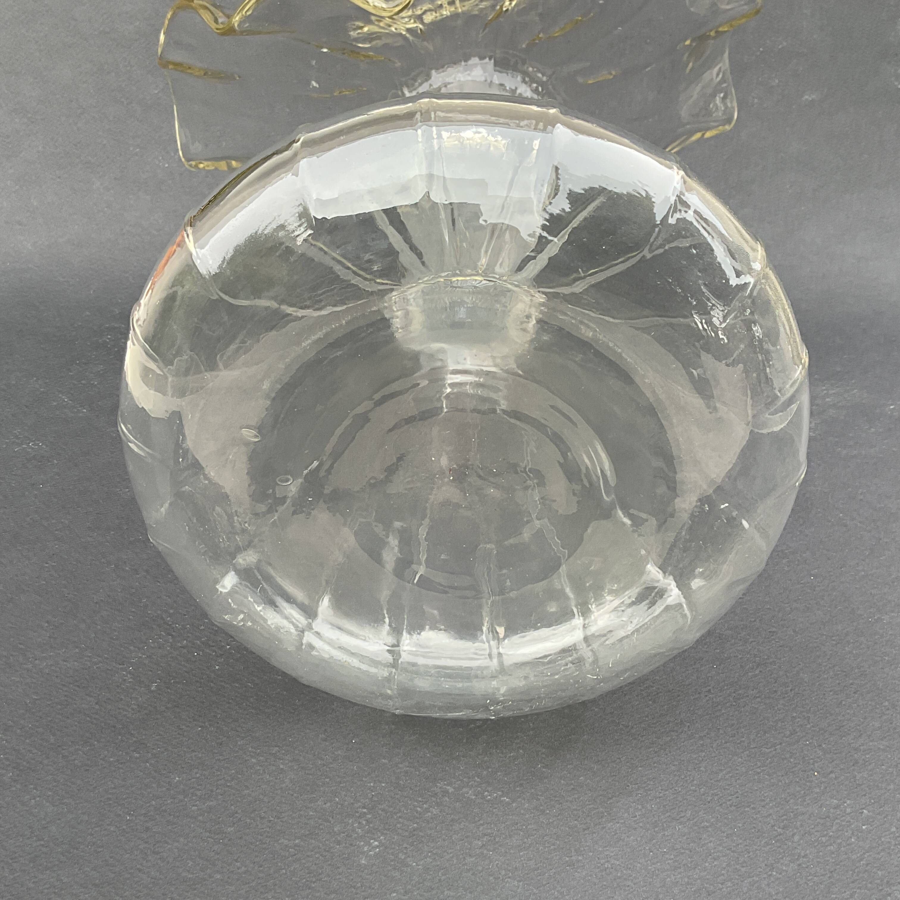 Vintage transparent glass vase in flower shape.