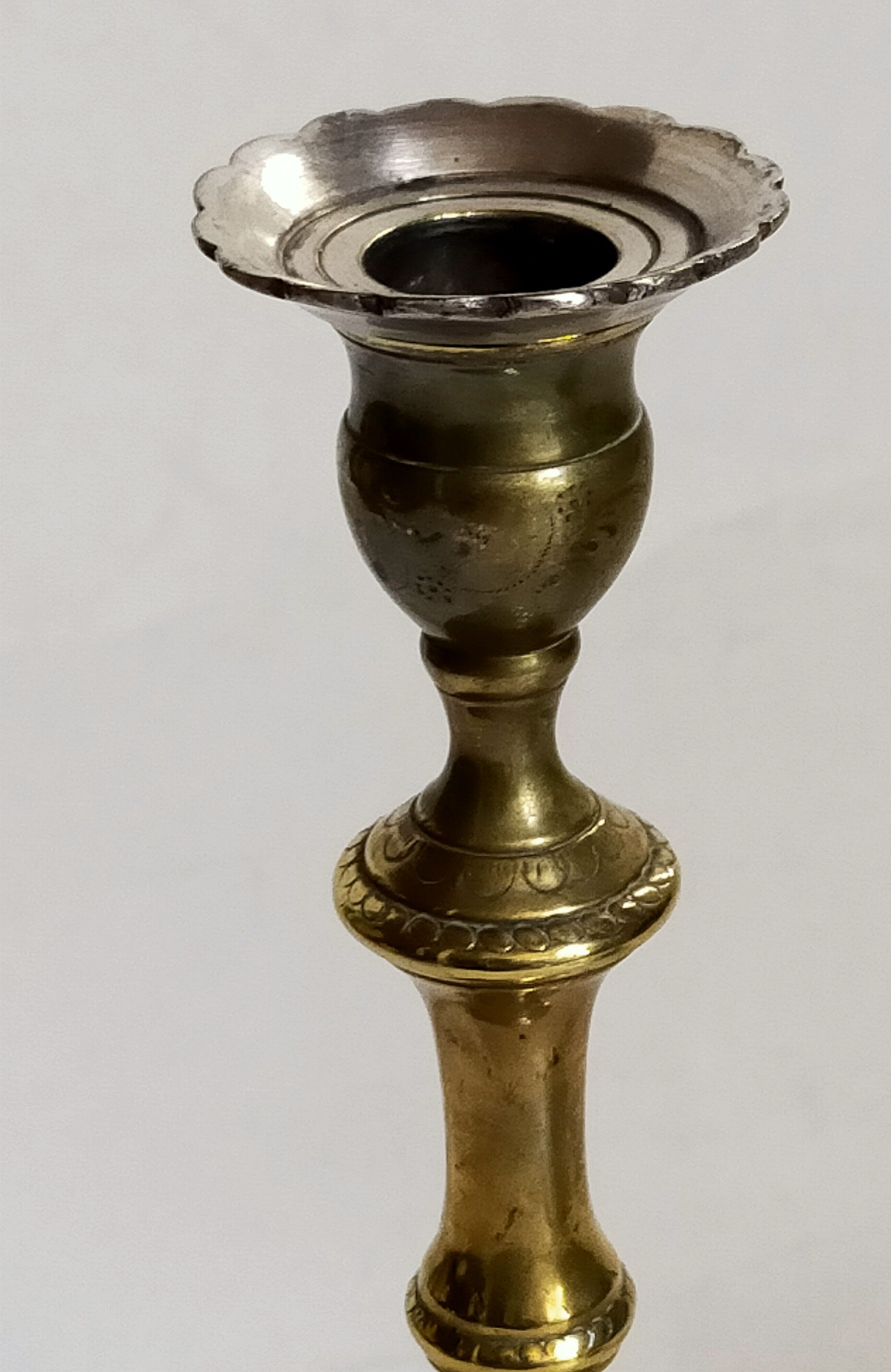 Duo of solid brass and gold metal candle holders worked old