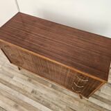 1950s chest of drawers covered in walnut with brass handles