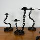 7 wrought iron candle holders in brutalist chain style