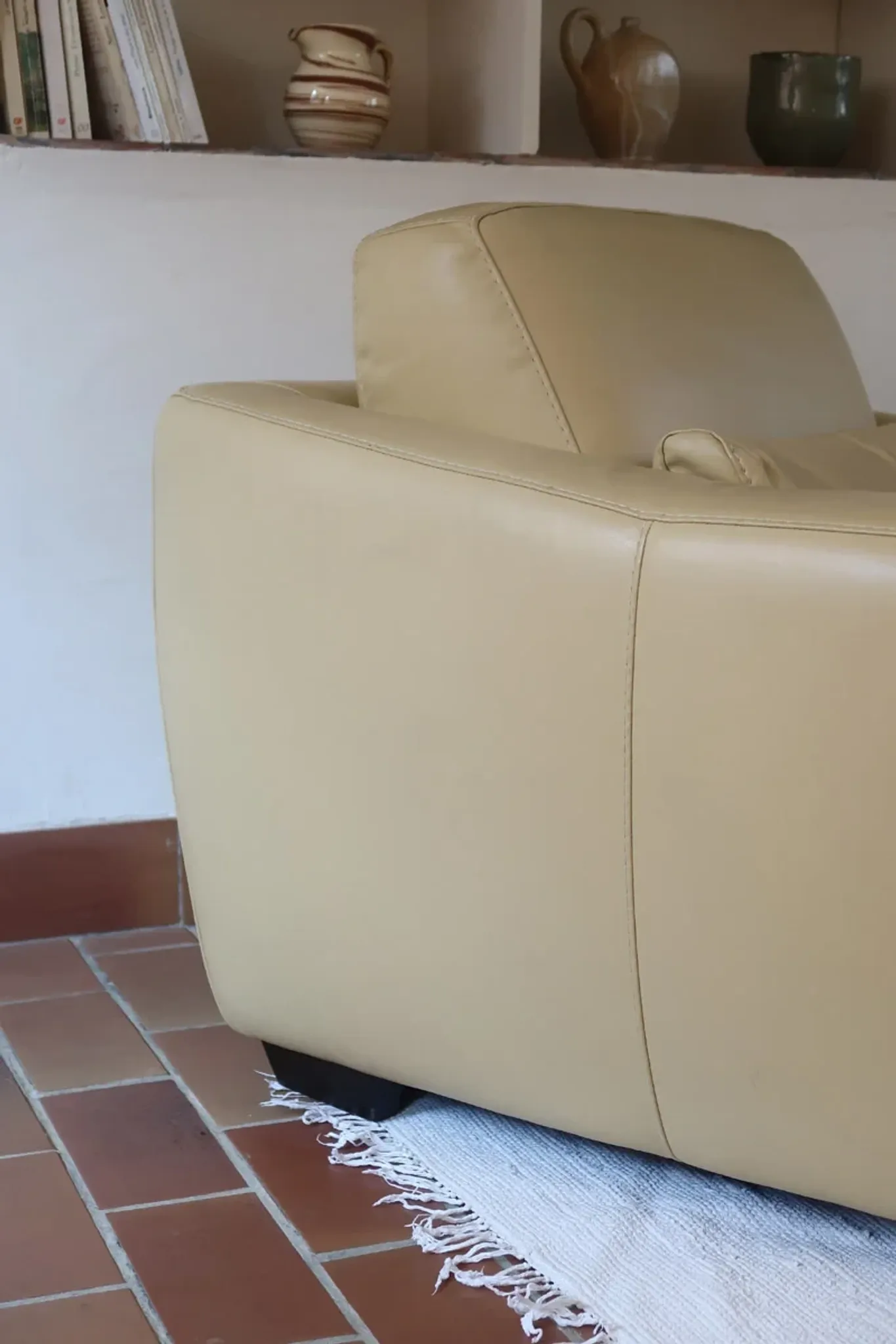 Vintage club armchair in butter yellow faux leather from the 1980s.