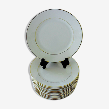 Suite of twelve table plates in white and gold porcelain.