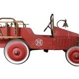 Old fire car with pedals, made of sheet metal.