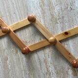 Extendable accordion coat rack in light wood