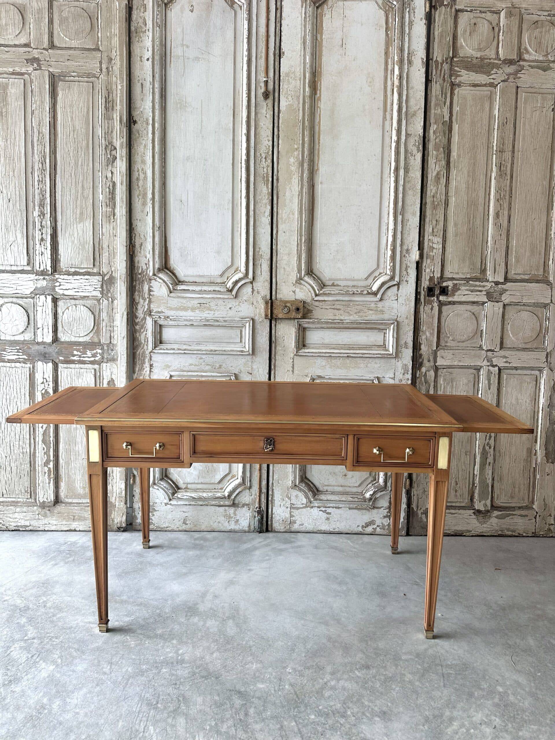 Directoire style flat desk circa 1960 in light cherry wood.