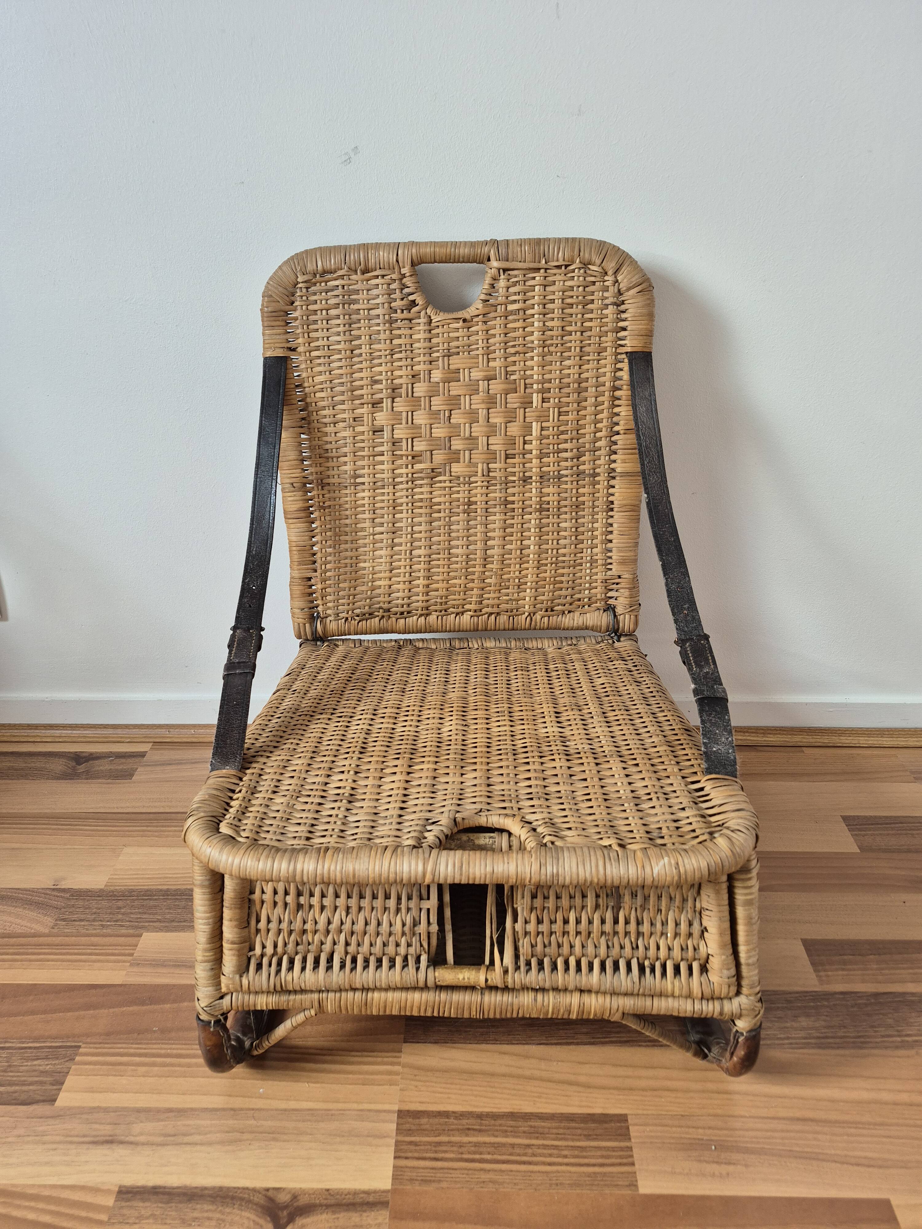 Vintage foldable beach chair, picnic in rattan and leather.
