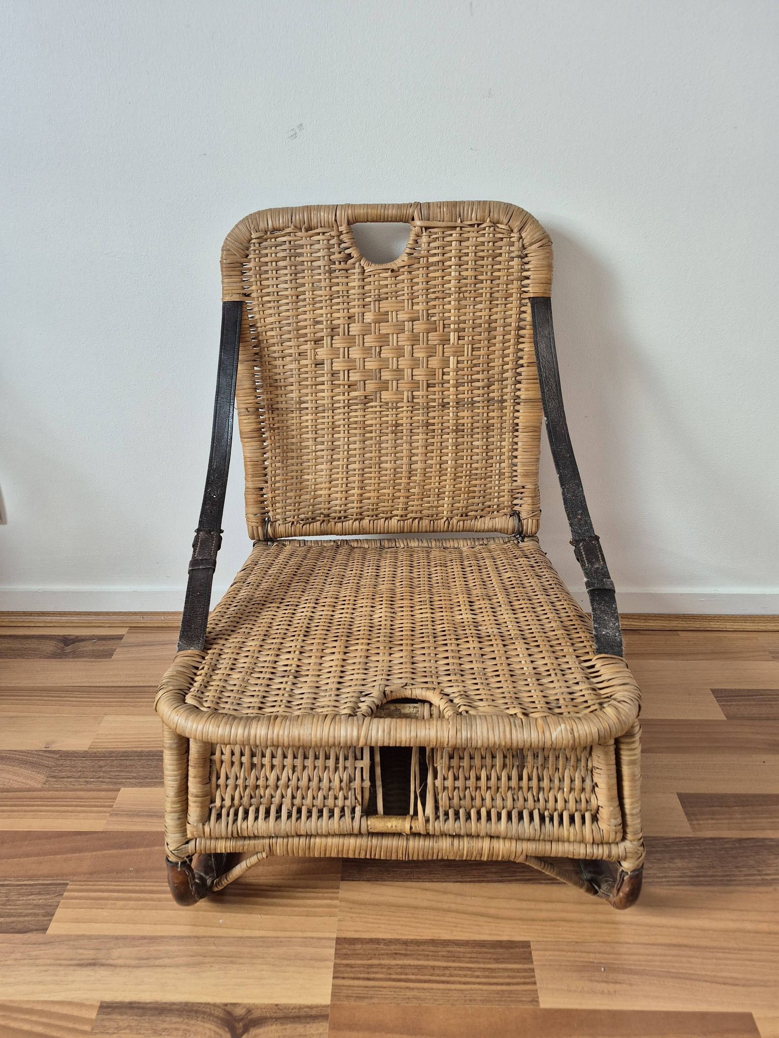 Vintage foldable beach chair, picnic in rattan and leather.