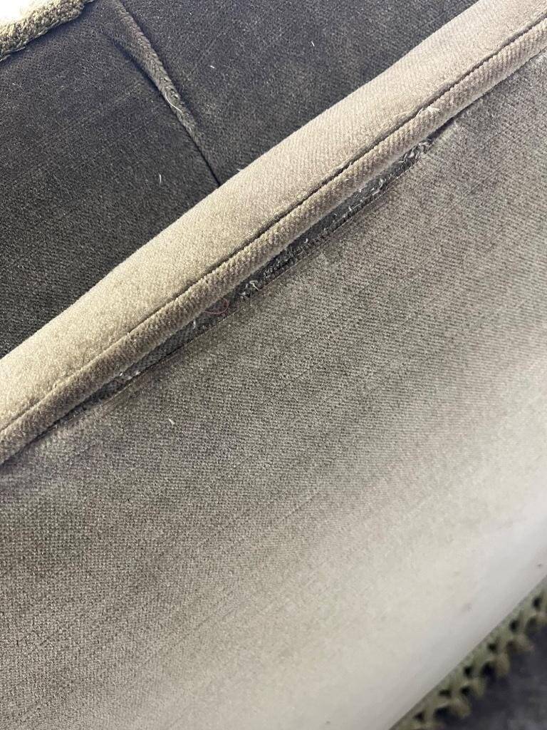 Vintage green two-seater sofa with fringes