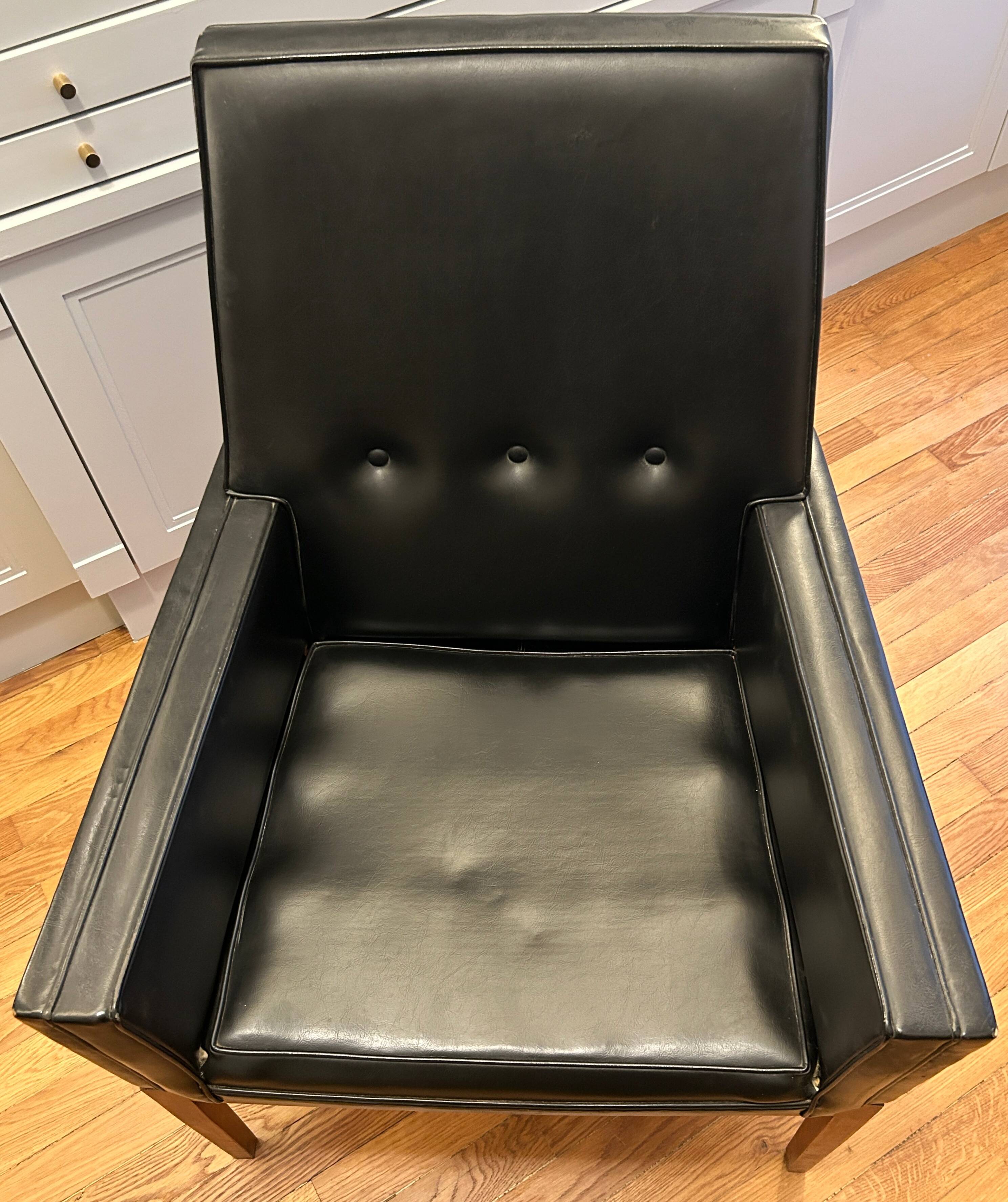 Modernist armchair in wood and black synthetic leather, circa 1960