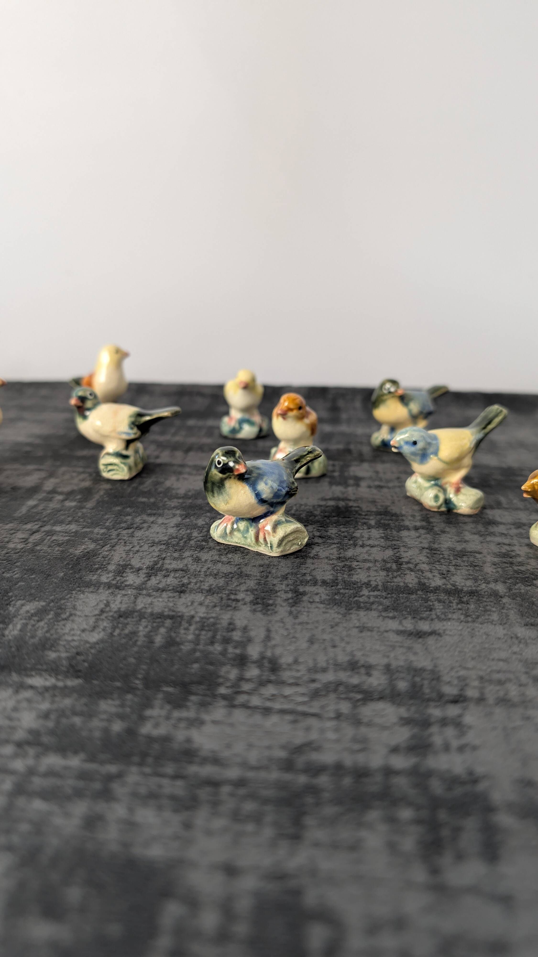 Set of 11 miniature birds in polychrome glazed ceramic.