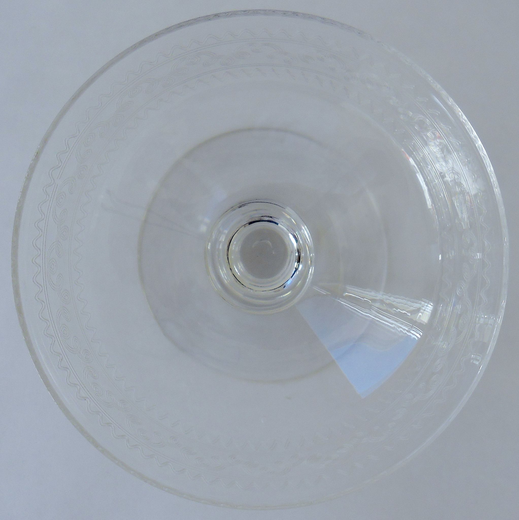 Suite of six champagne glasses on foot in engraved colorless crystal