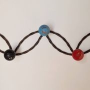 Vintage wall-mounted coat rack in wrought iron with coloured balls - Roger Feraud