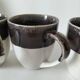 Set of three two-tone mugs, glazed stoneware, café workshop style.