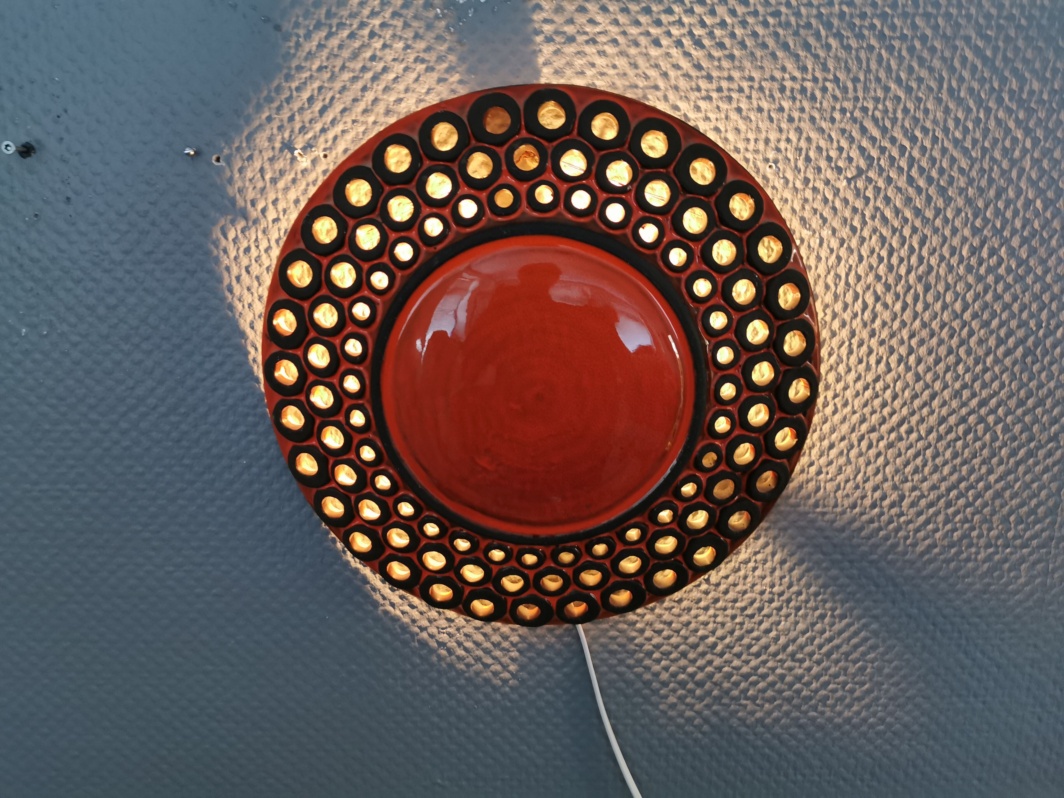 Wall light made from brown and red ceramic. Signed Norman Motala Sweden 1970s.