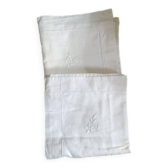 2 Pillowcases with flower decoration and satin stitch surround.