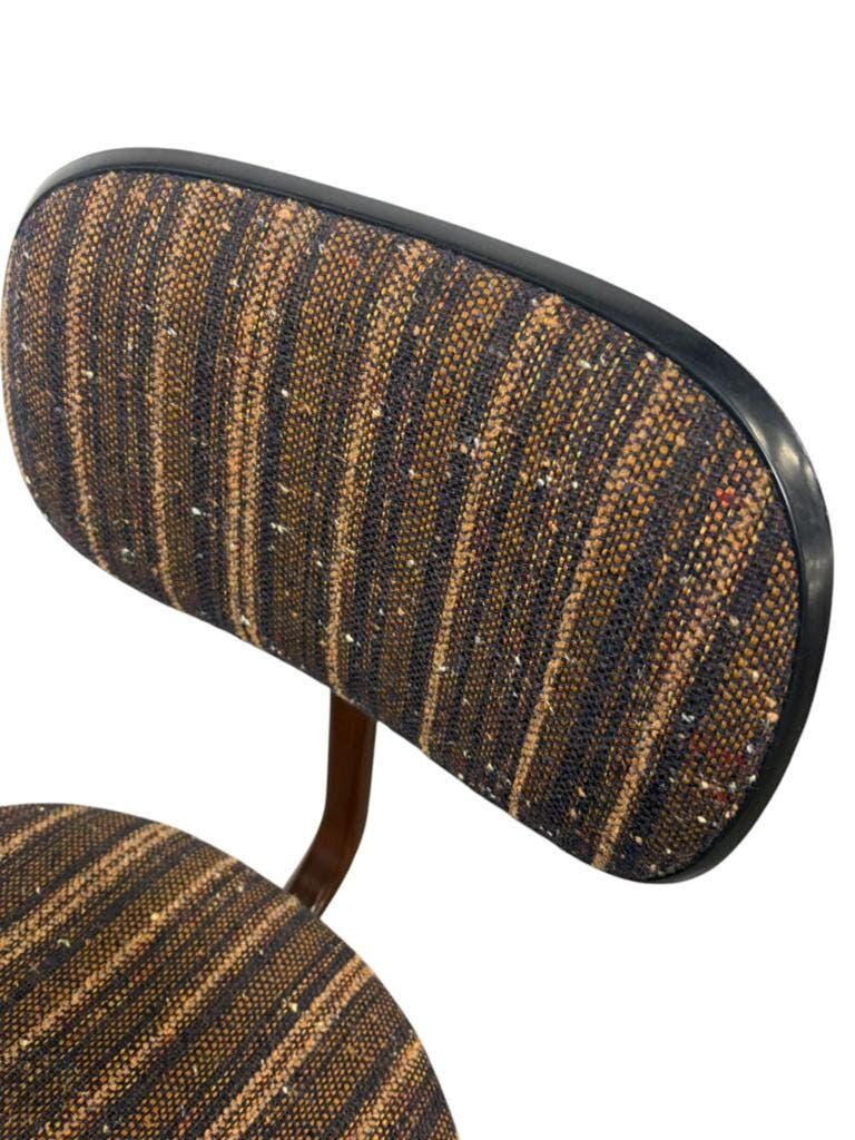 Brown vintage office chair from the 70s on wheels.