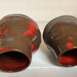 Pair of red vases in the shape of an elephant's foot