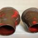 Pair of red vases in the shape of an elephant's foot