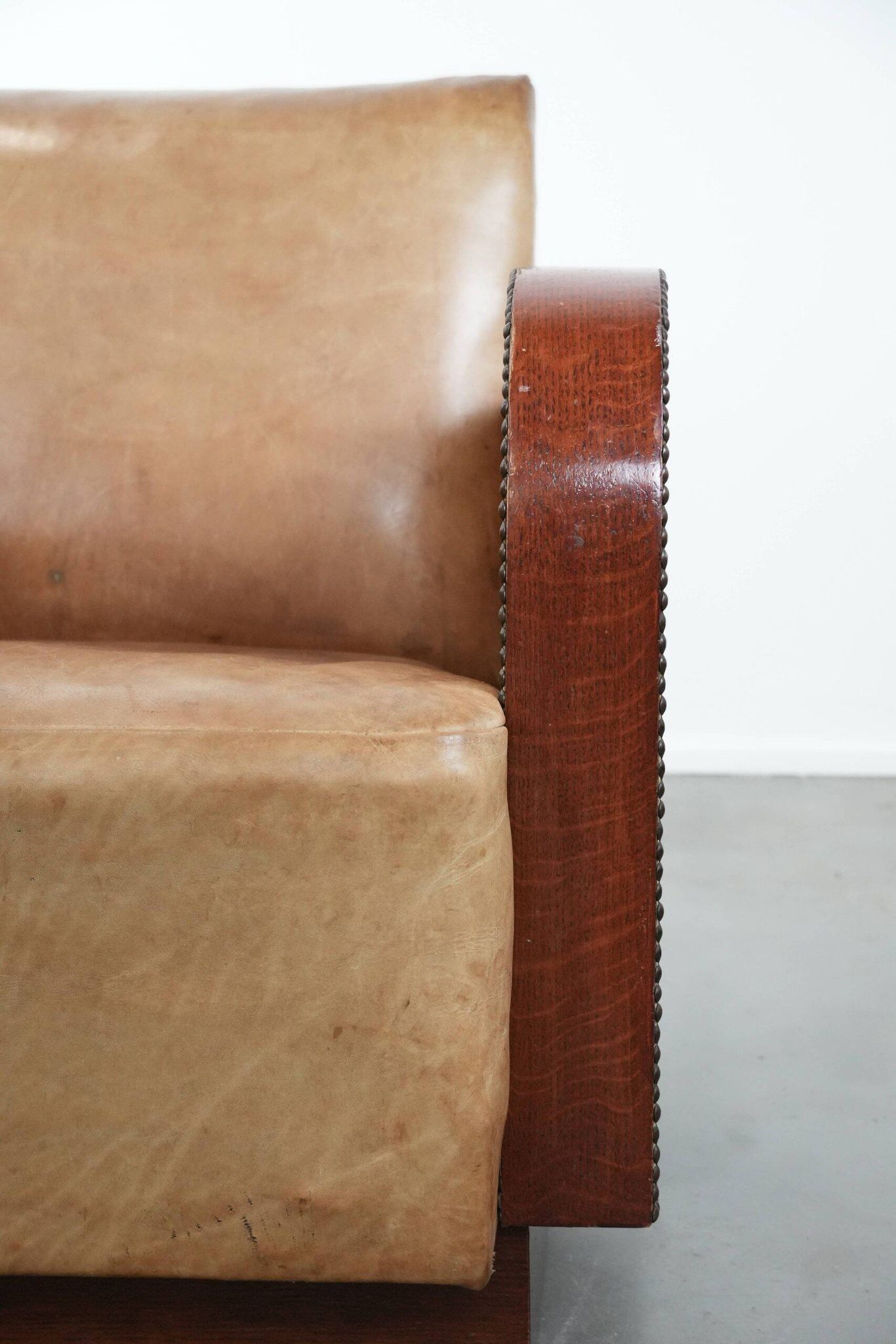 Art Deco design armchair in light cognac cowhide leather.
