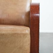Art Deco design armchair in light cognac cowhide leather.