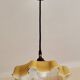 Electrified suspension with a frosted opaque glass disc shade.