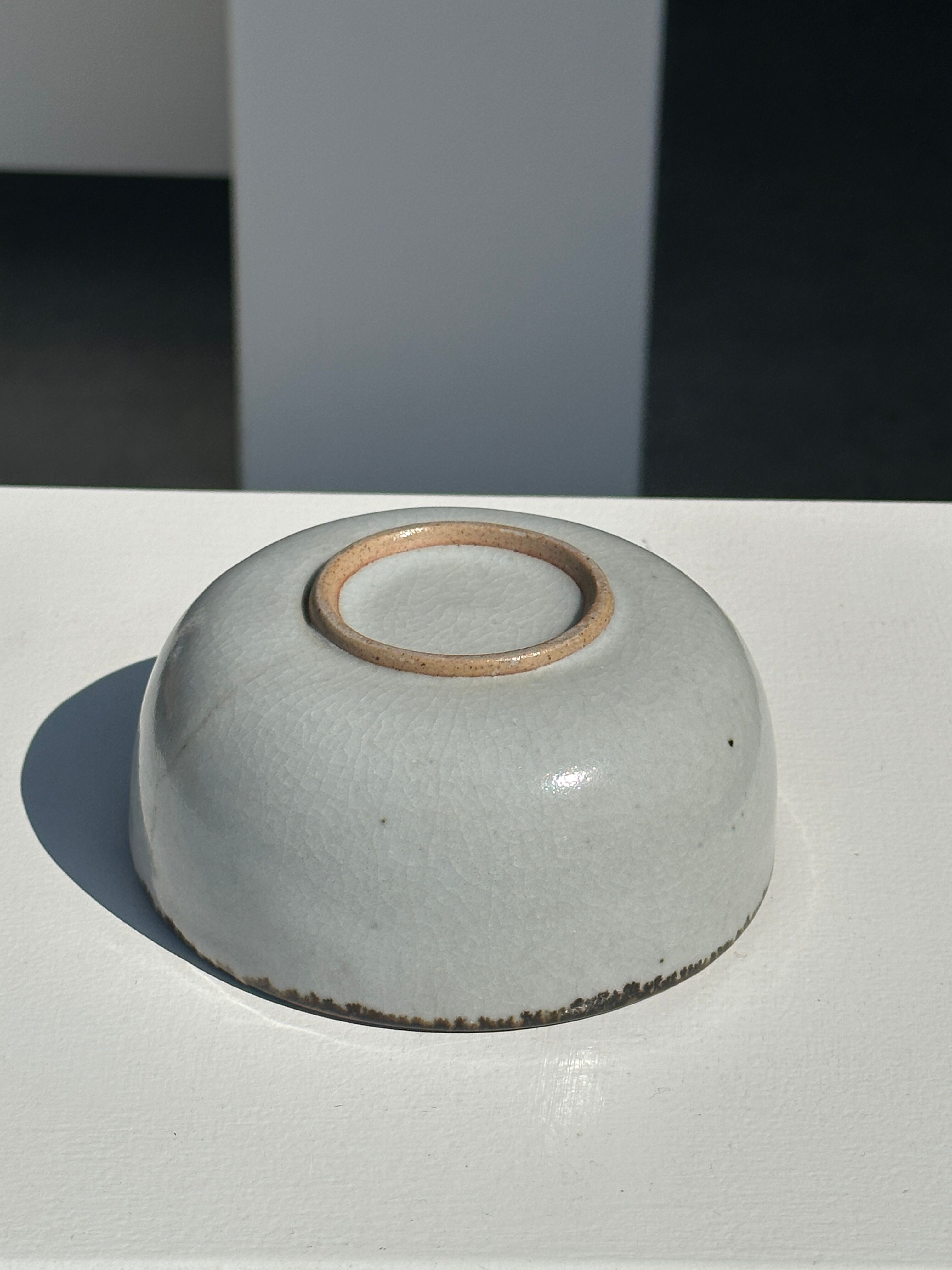 Small white glazed ceramic bowl black edges