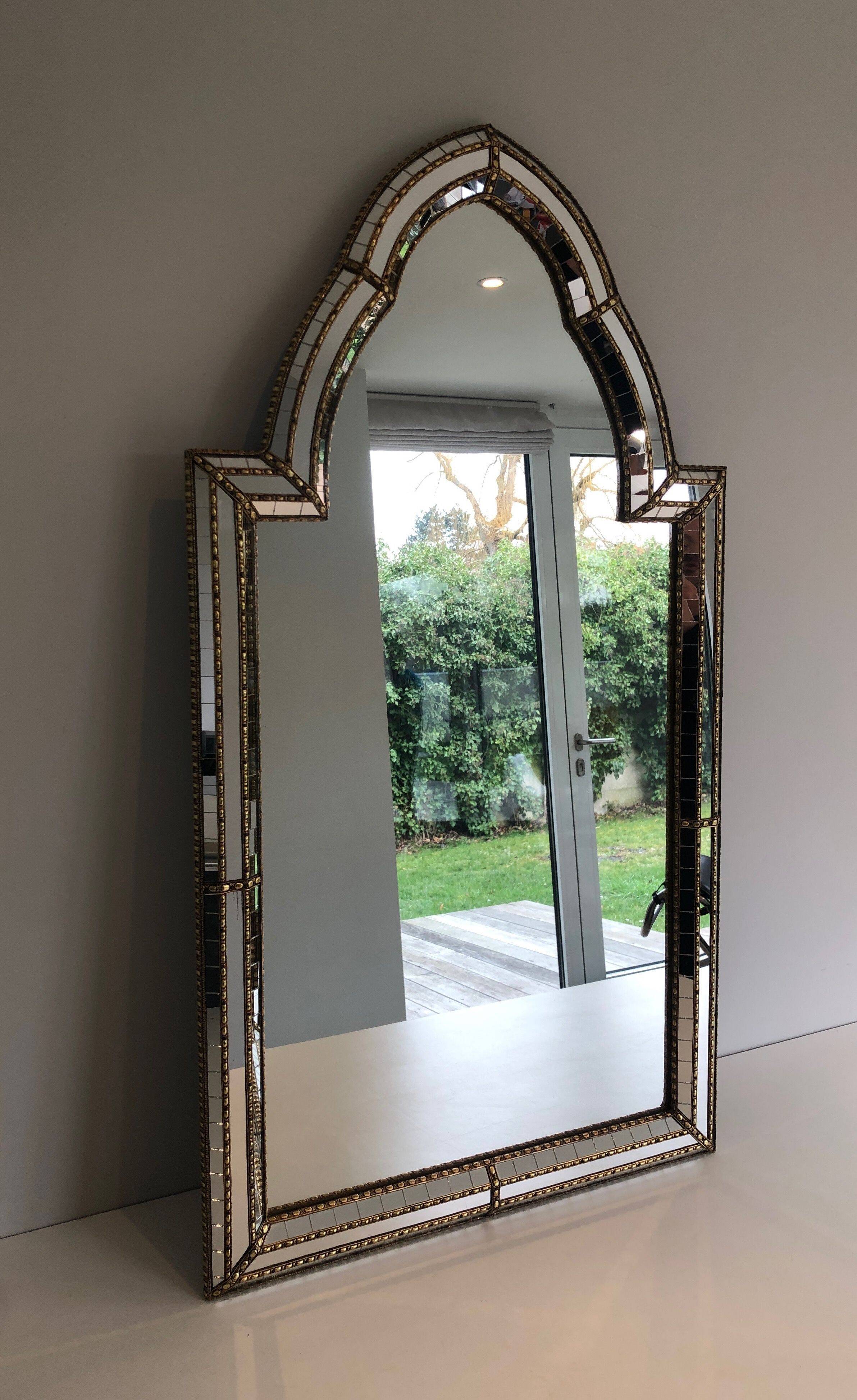 Multi-faceted mirror and brass garlands