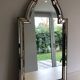 Multi-faceted mirror and brass garlands