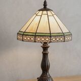 Tiffany-style stained glass lamp in green and amber white with vintage inspiration.