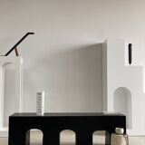 Black solid monoxyl wood bench carved into 3 arches