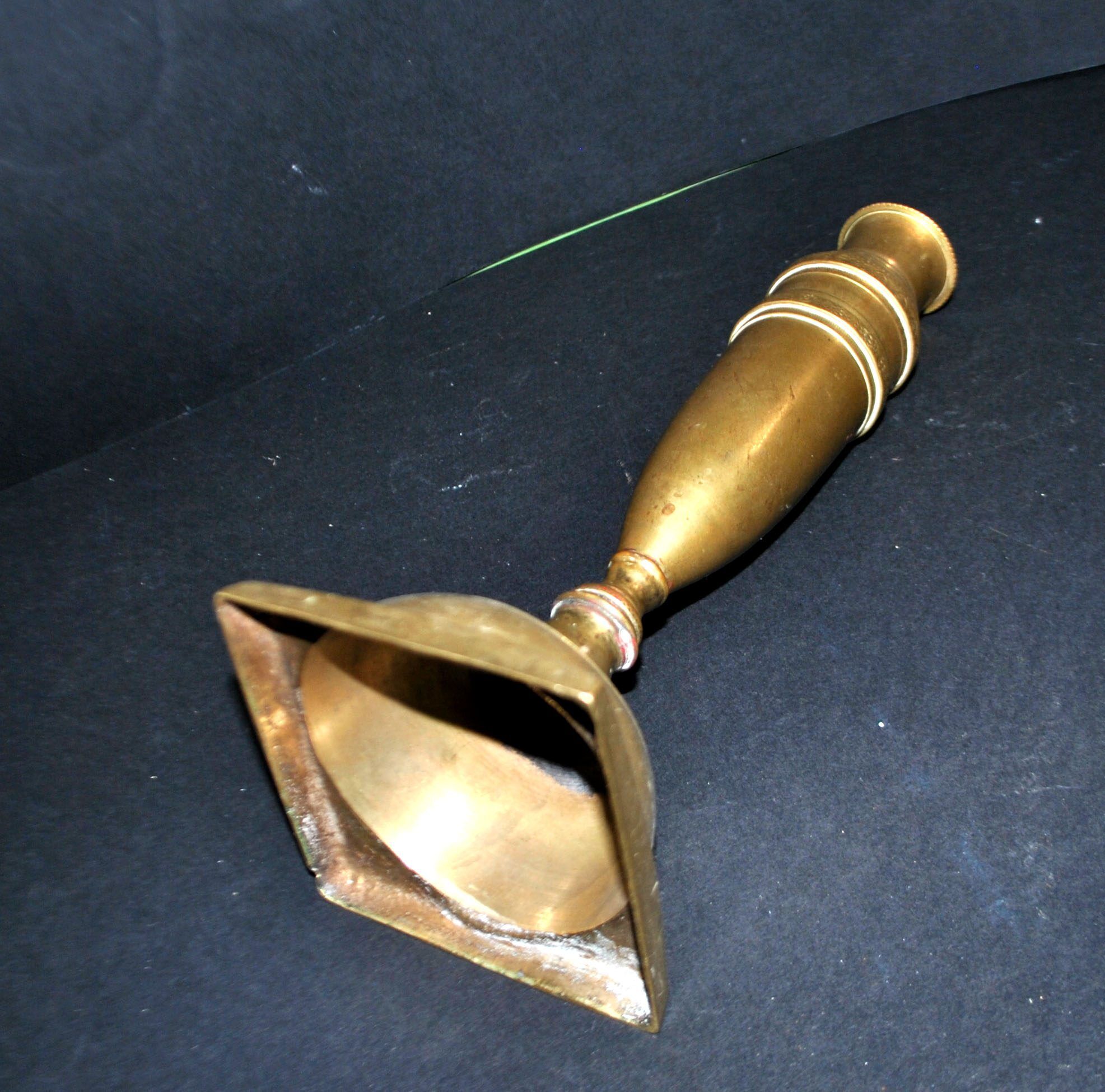 Antique baluster candlestick in bronze with hand-chiseled design.
