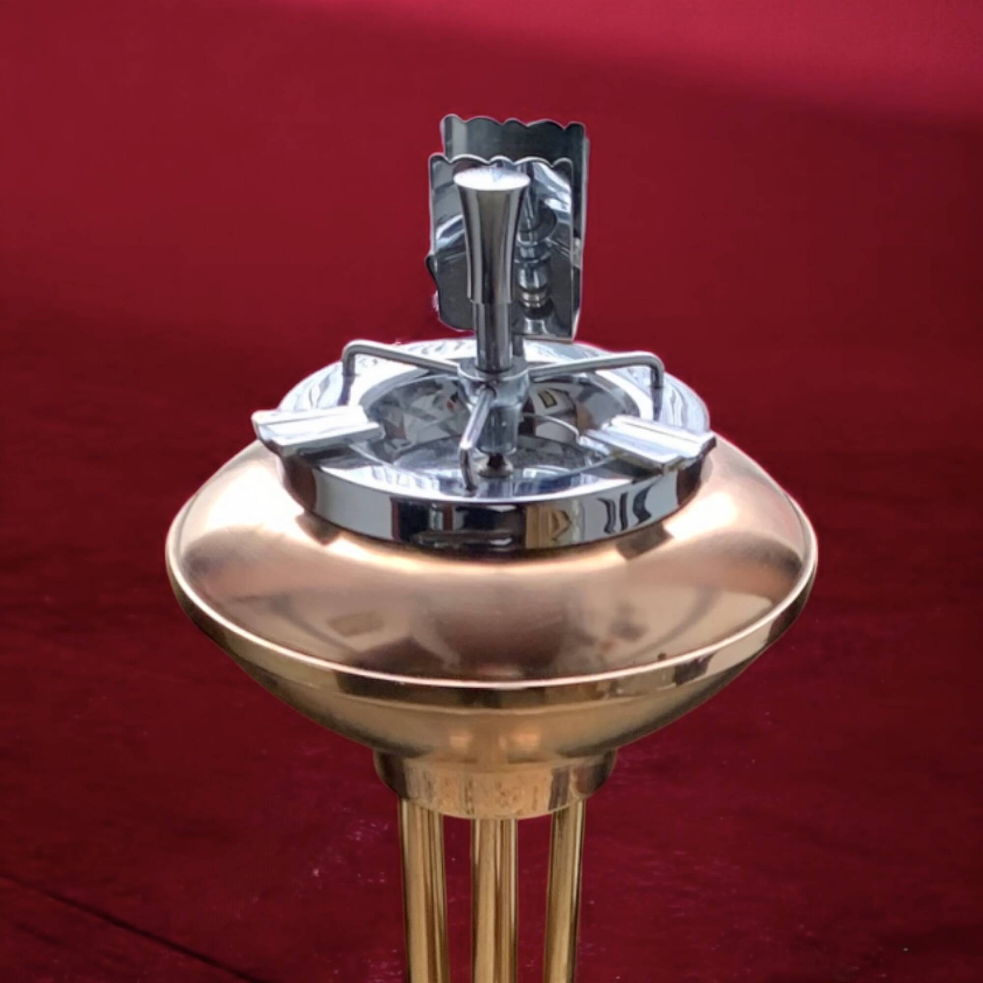 Old brass and chrome-plated metal ashtray on stand