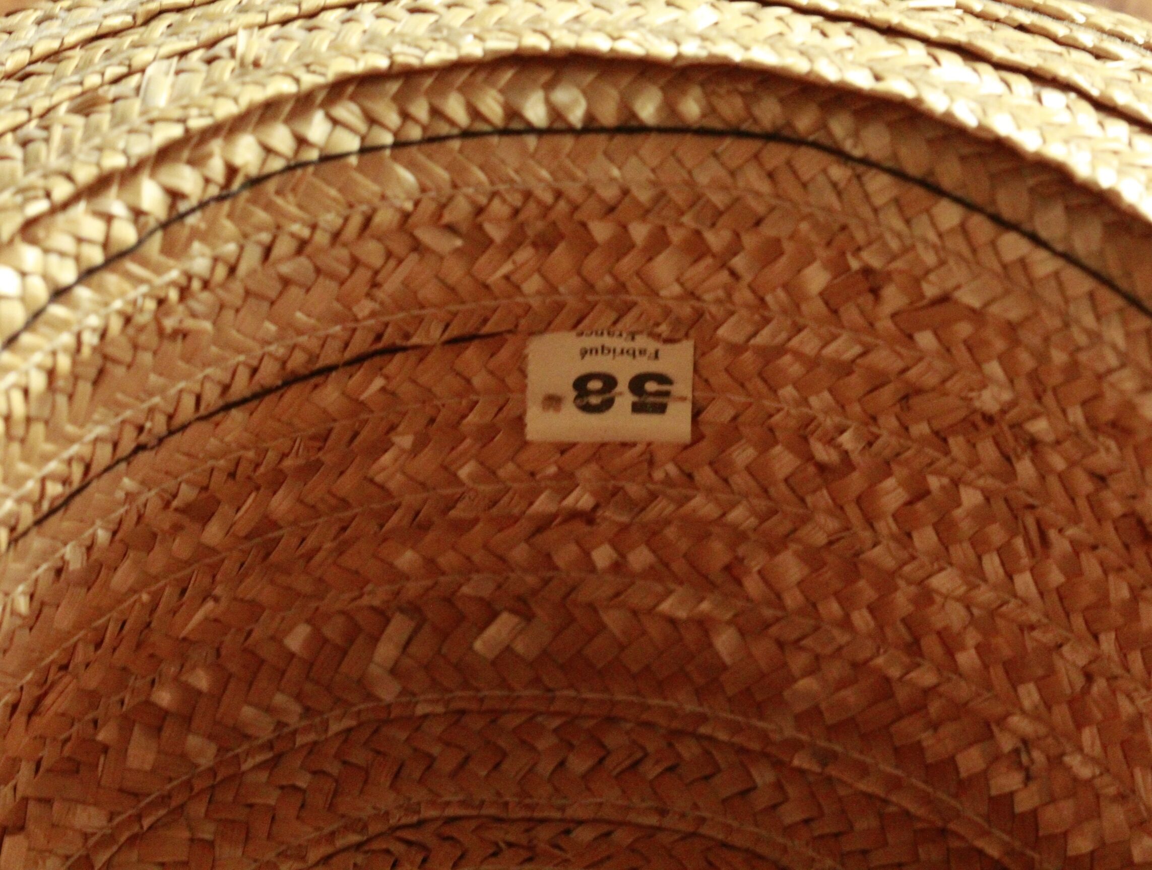 Old straw hat with black ribbon
