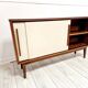 Mid-century teak sideboard with white synthetic doors.